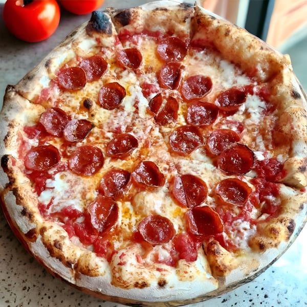 A freshly baked pepperoni pizza from Crab Rock PIZZA with a bubbly crust and melted cheese.